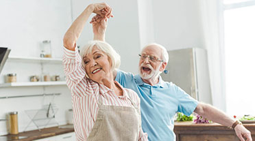 Elderly couple dancing in their kitchen