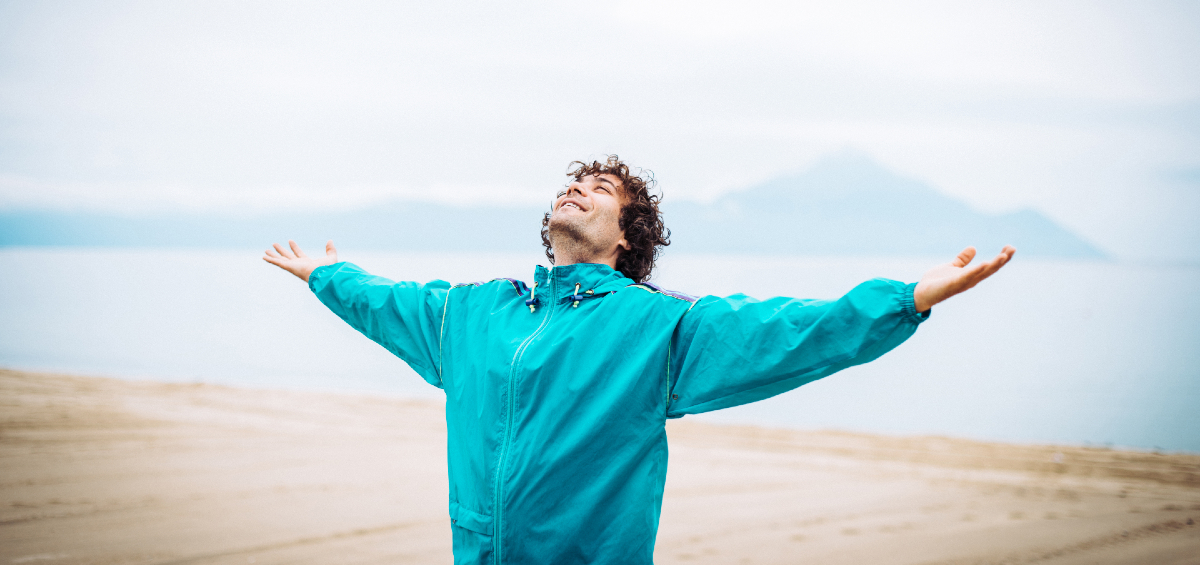 Man on beach looking happy