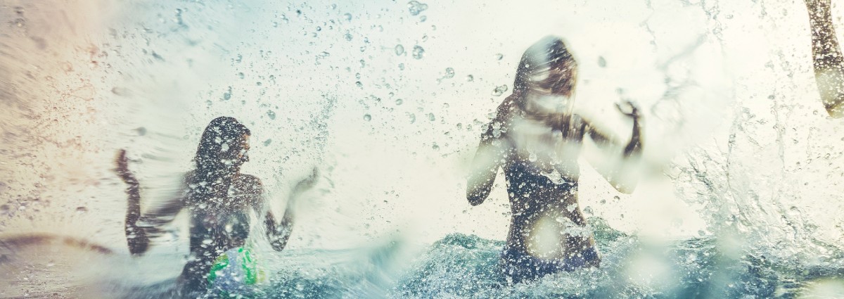 people splashing in the sea