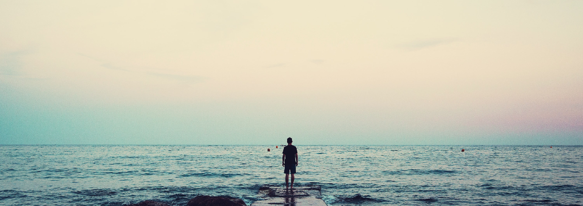 man looking out over water