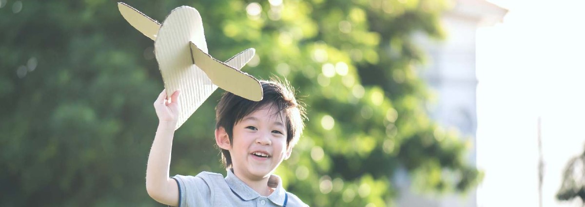 child with toy plane