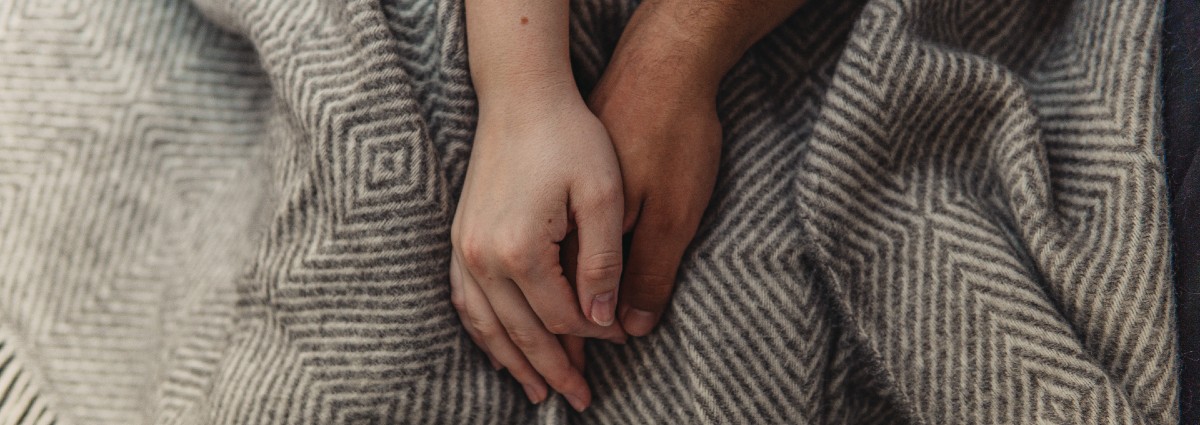 holding hands on blanket