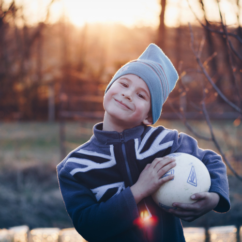 boy looking happy with a football