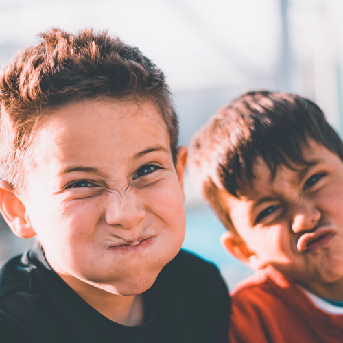 Two boys pulling faces