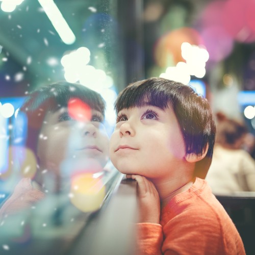 Child looking up against window