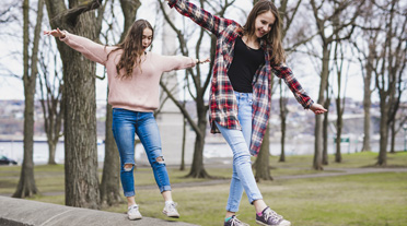 children walking along a wall