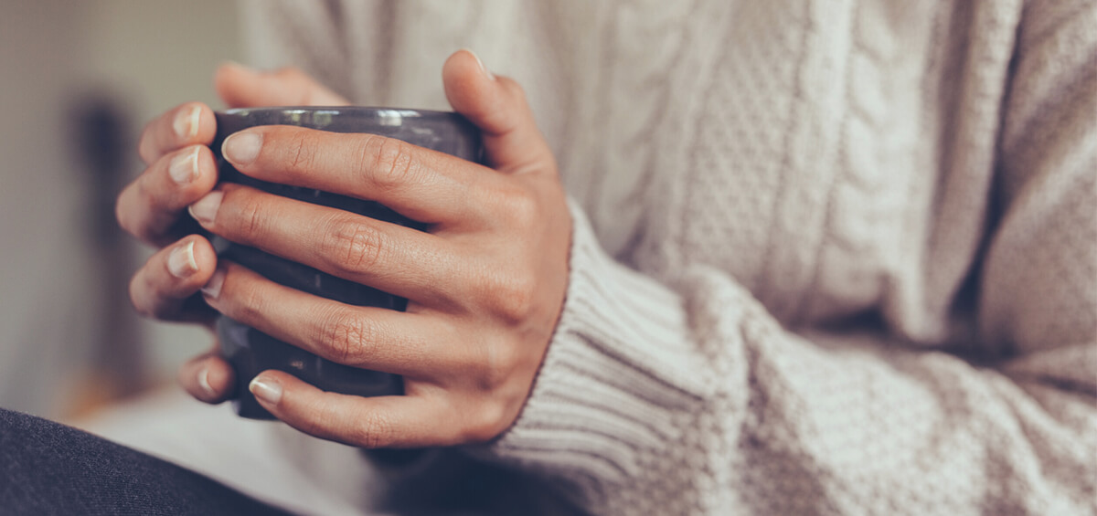 person holding a mug of tea