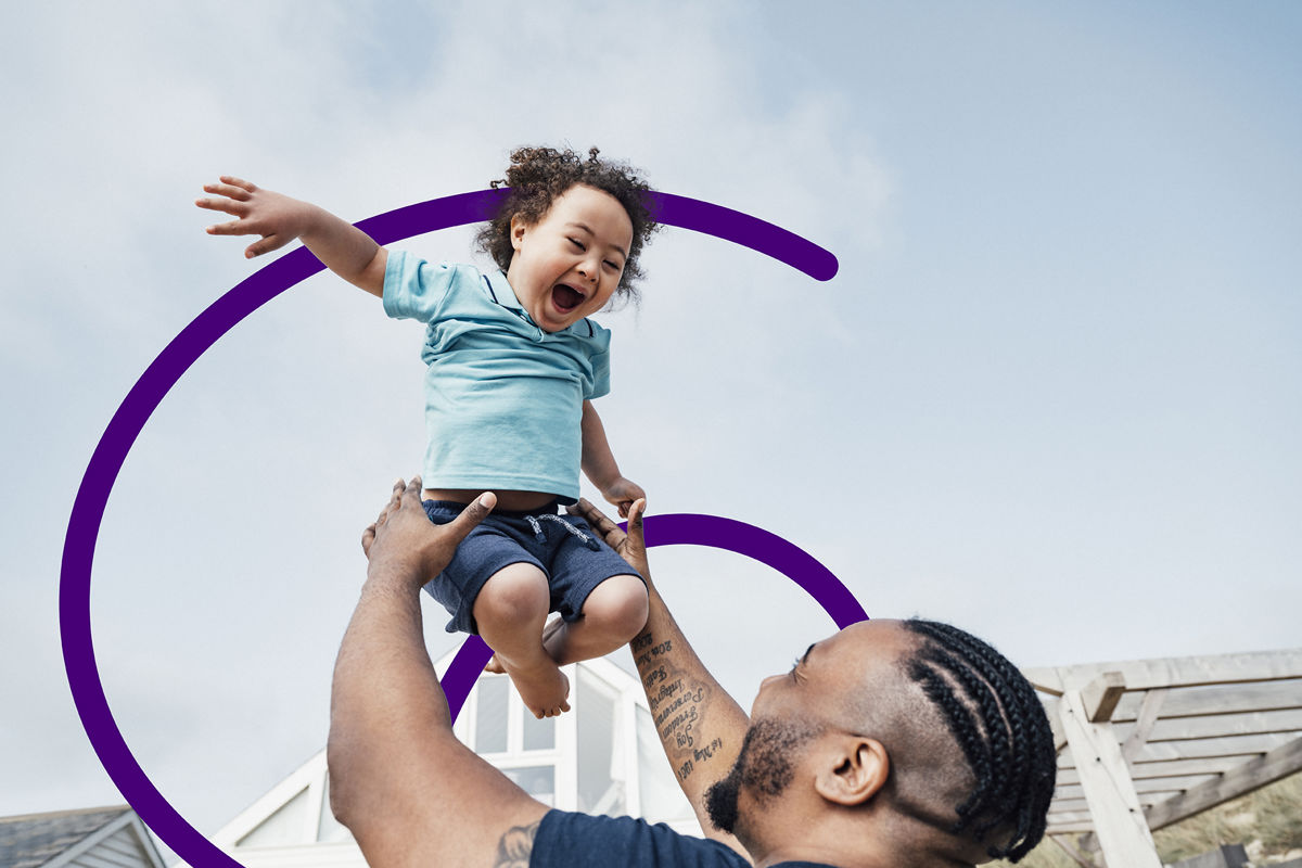 Man playfully holding child in the air.jpg
