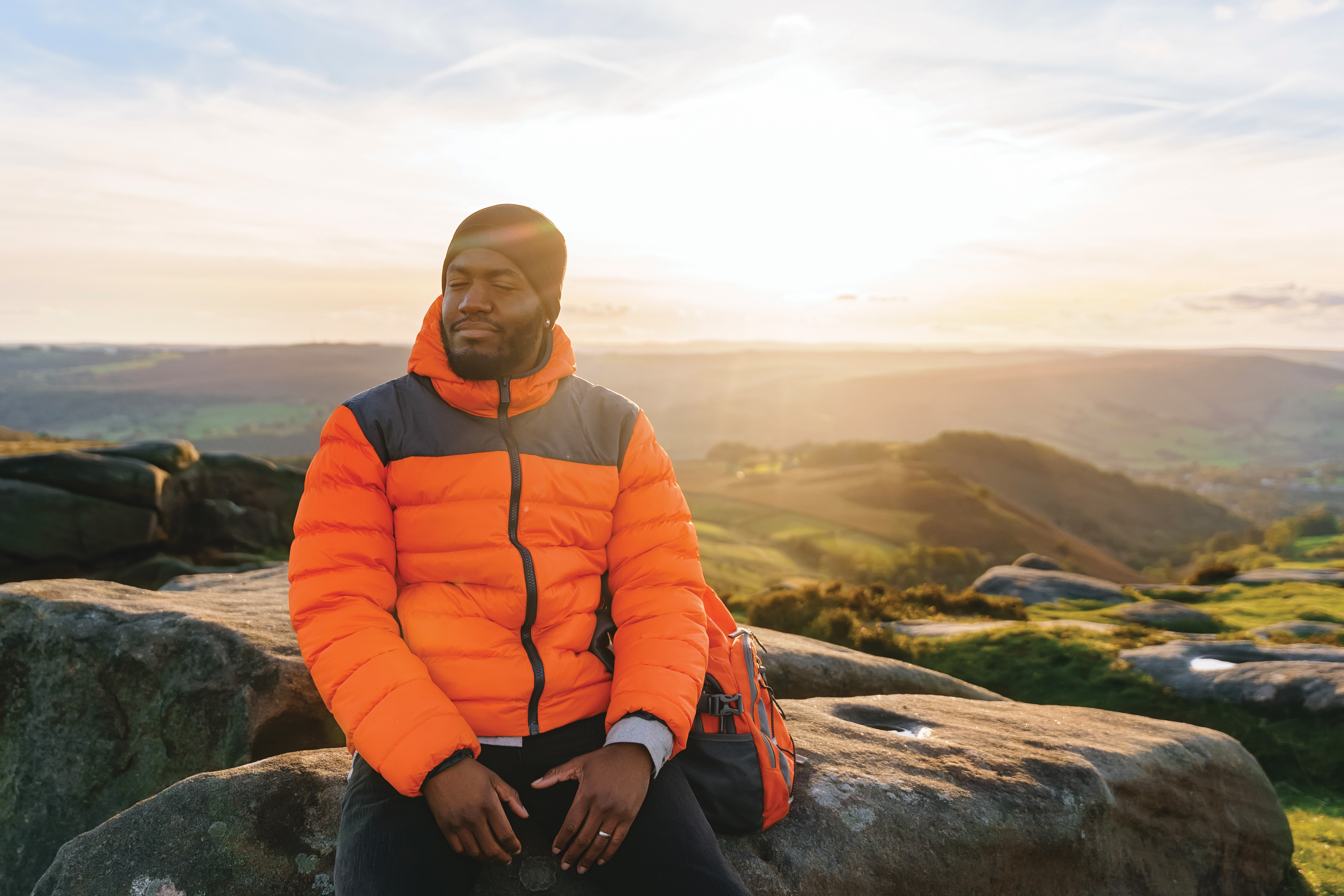 Man sitting on a rock during a hike.jpg