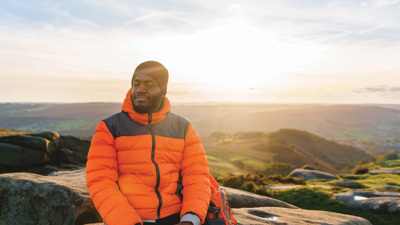 Man sitting on a rock during a hike.jpg