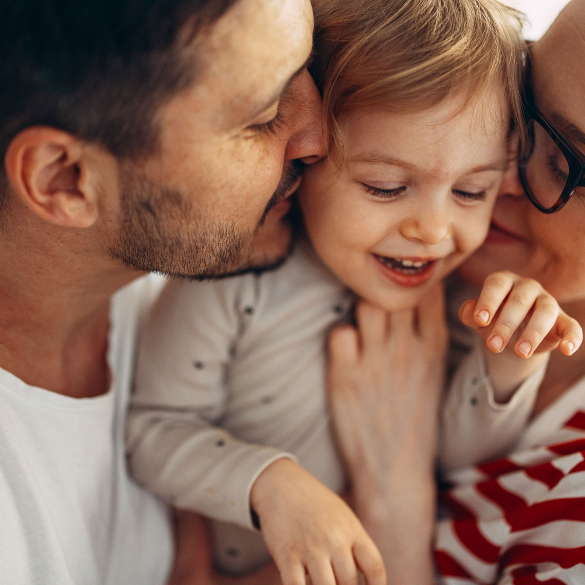 Parents holding a young child.jpg