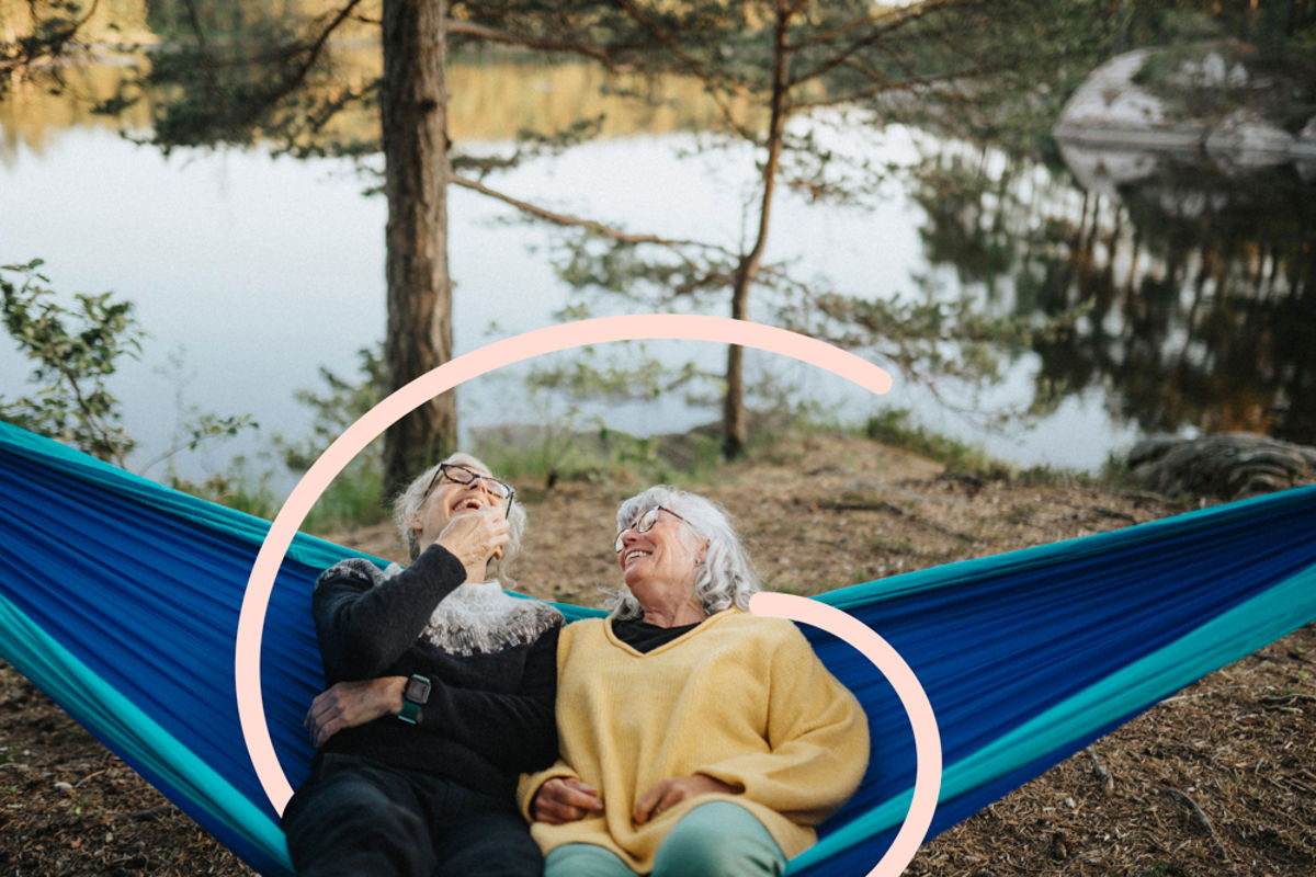 Two women sitting in a hammock in scenic location.jpg