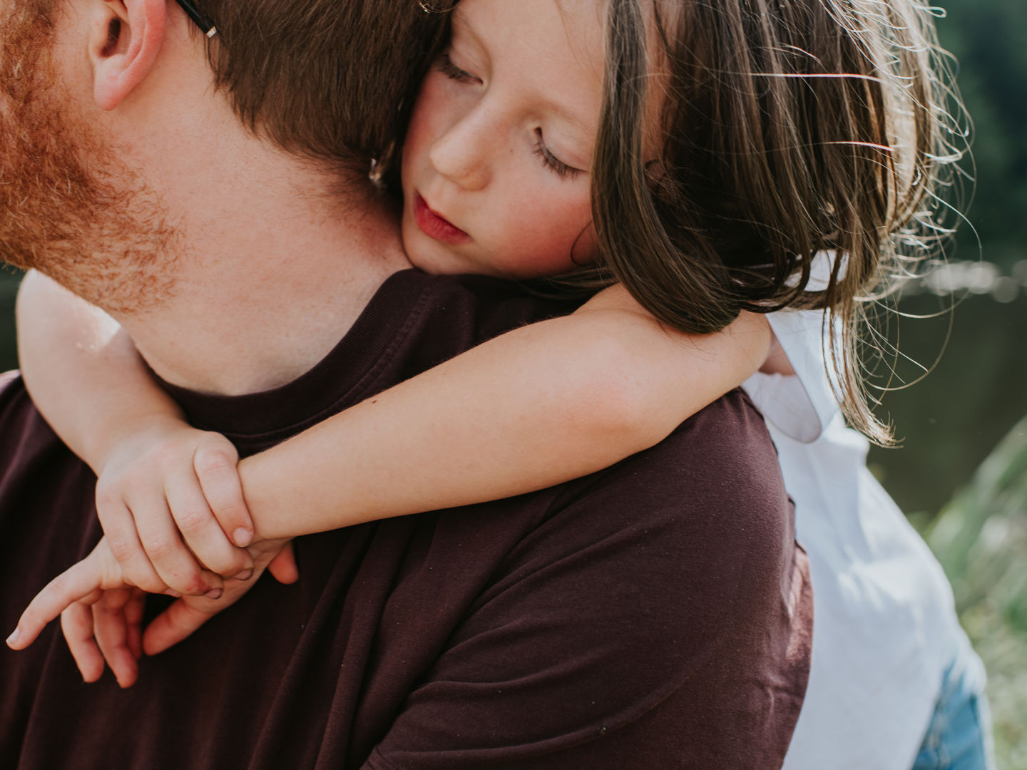 Father carrying young daughter on his back