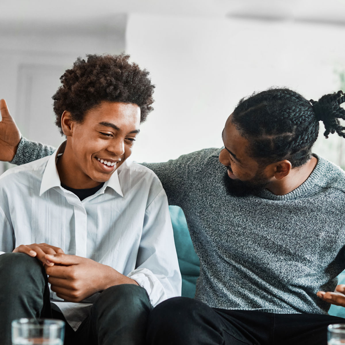 Man and teenager sitting on sofa.jpg