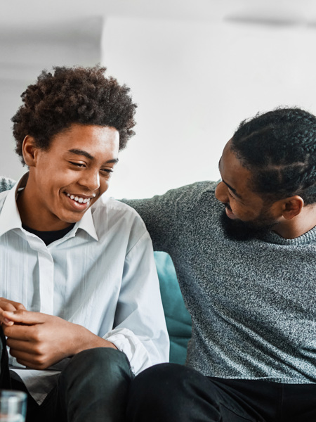 Man and teenager sitting on sofa.jpg