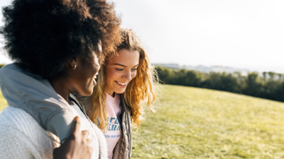 Two people together walking arm in arm.jpg
