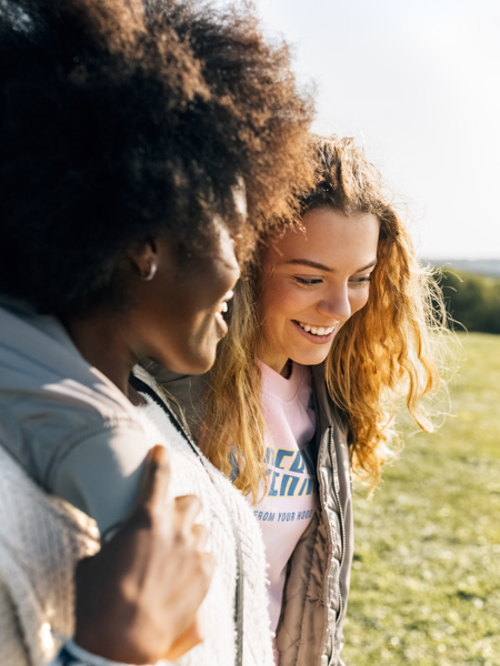 Two people together walking arm in arm.jpg