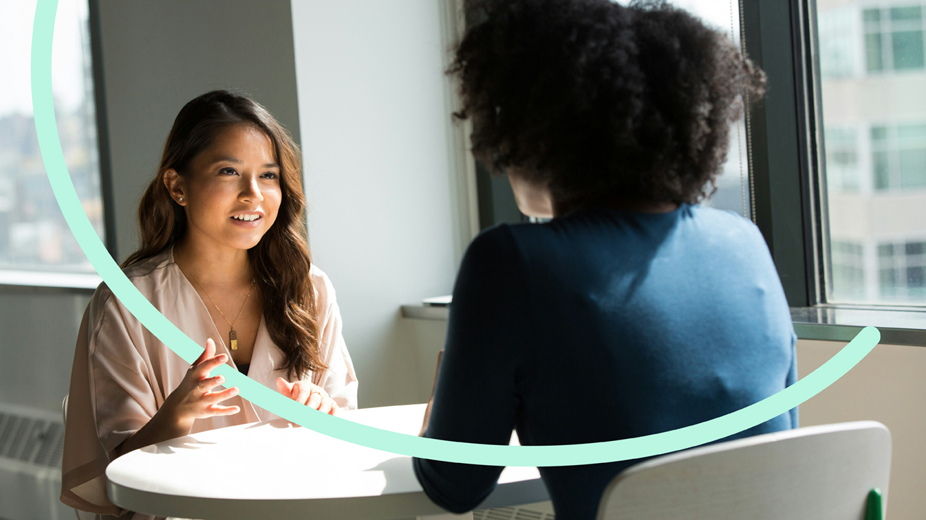 Interview setting with two women sitting at a table.jpg