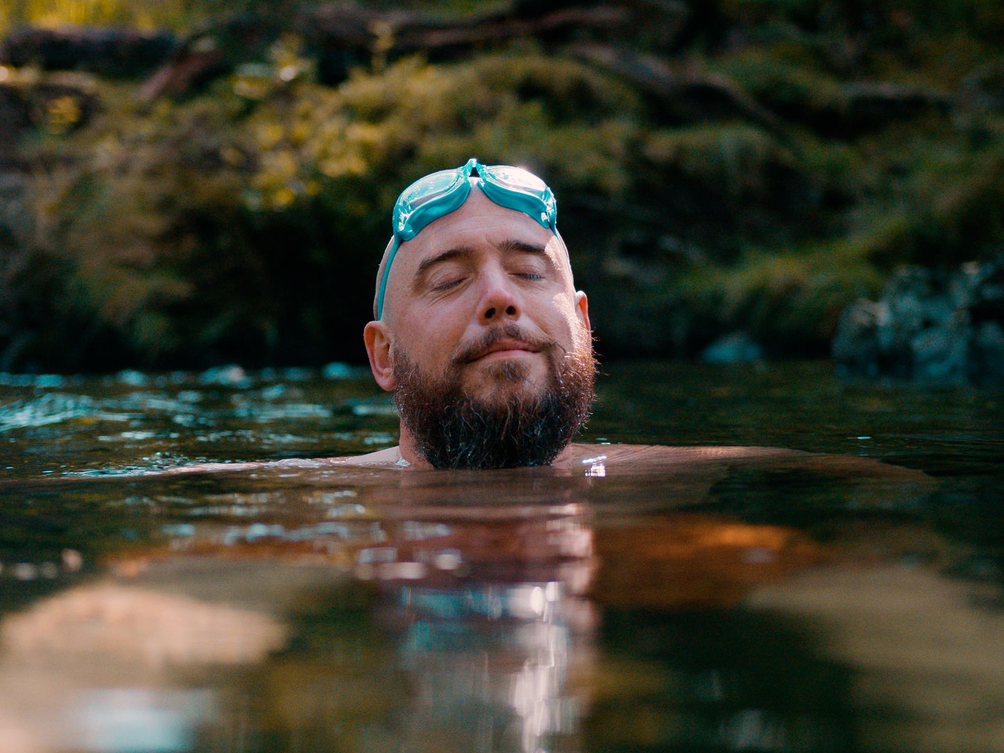 Man wild swimming in a river
