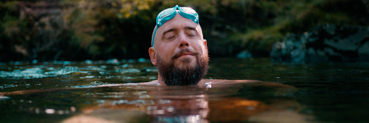 Man wild swimming in a river.jpg