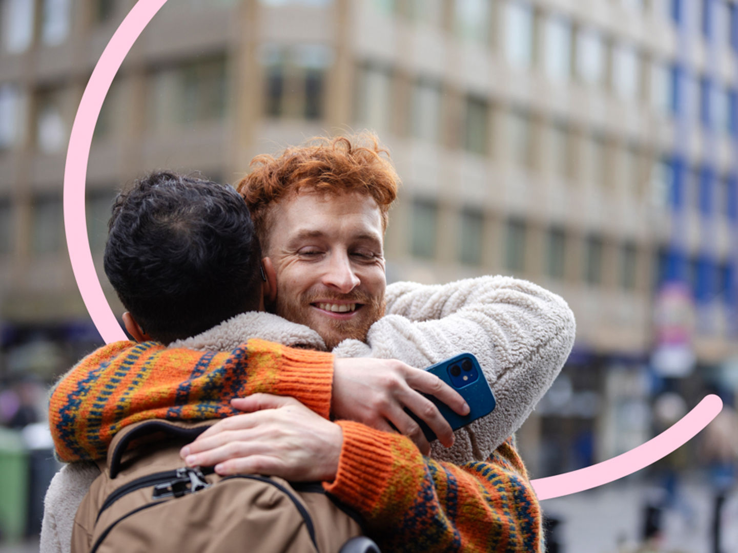 Two men hugging outside