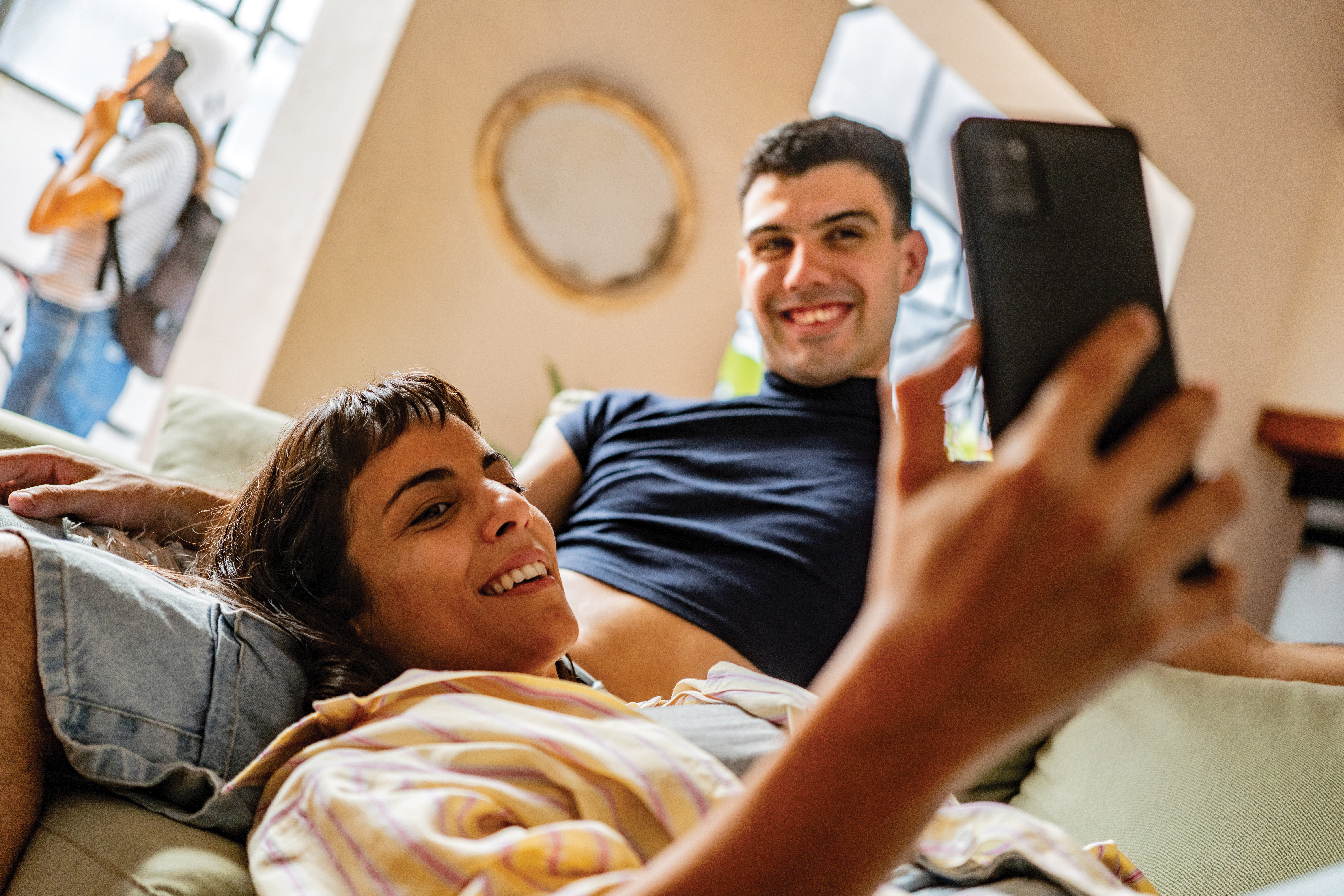Two people relaxed while looking at a phone.jpg