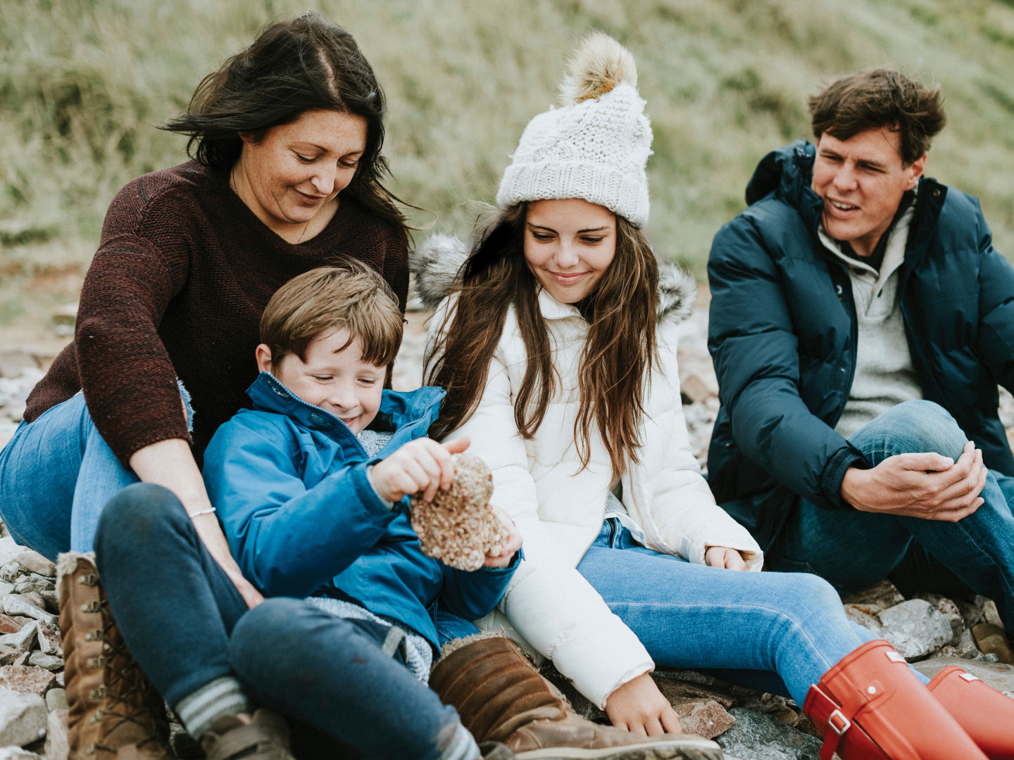 Family sitting on the beach in winter