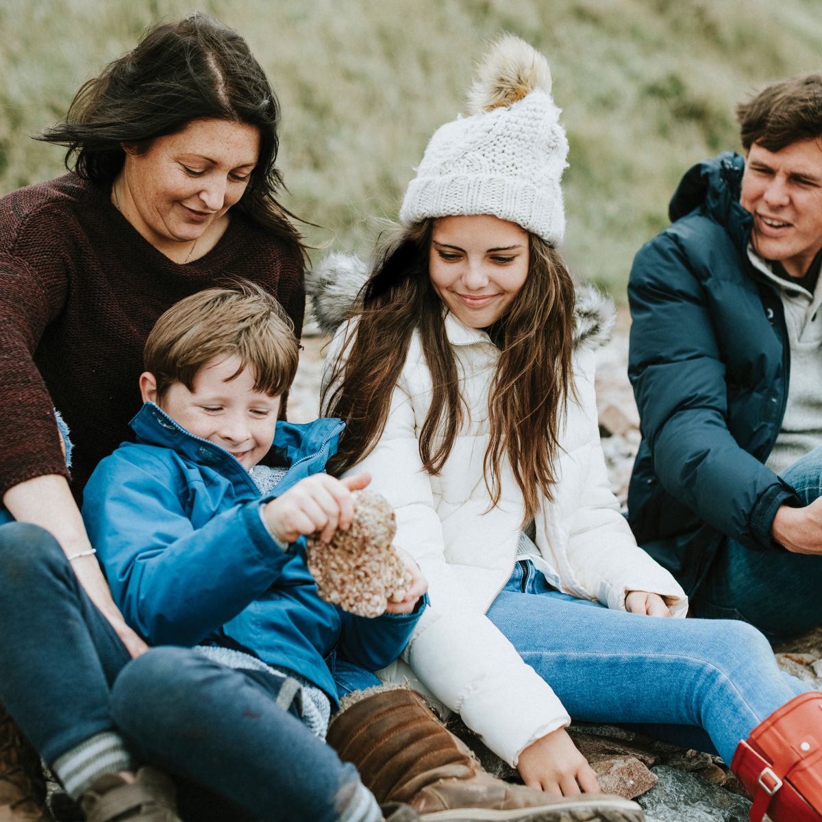Family sitting on the beach in winter.jpg