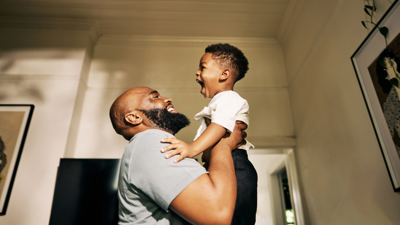Man holding up child at home.jpg