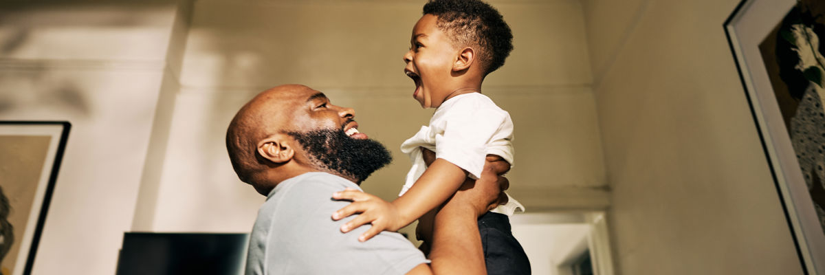 Man holding up child at home.jpg