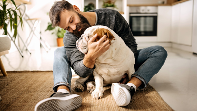 Man sitting on the floor with a dog.jpg
