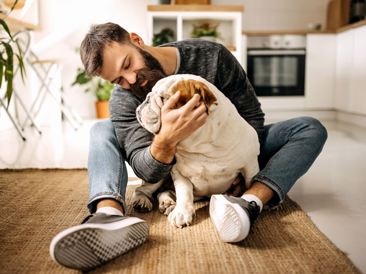 Man sitting on the floor with a dog.jpg