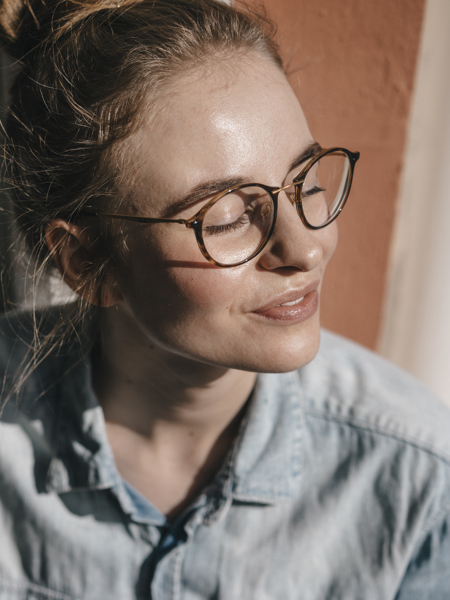 Woman wearing glasses looking towards the sun with eyes closed.jpg