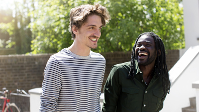 Two men outside walking together.jpg