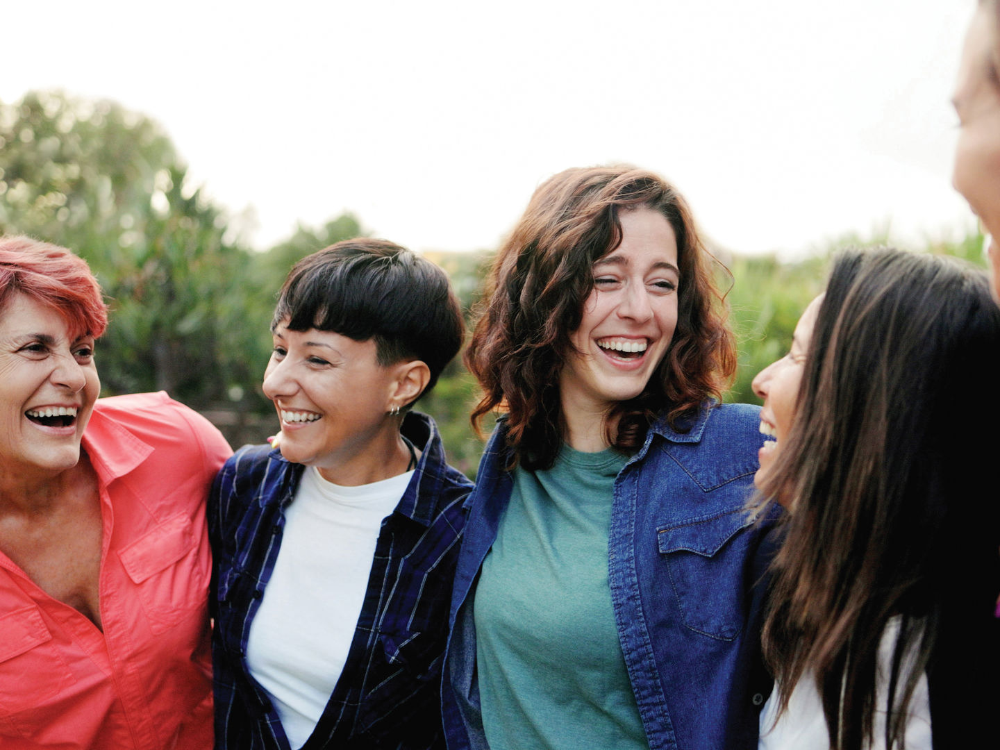 Group of people smiling at one another
