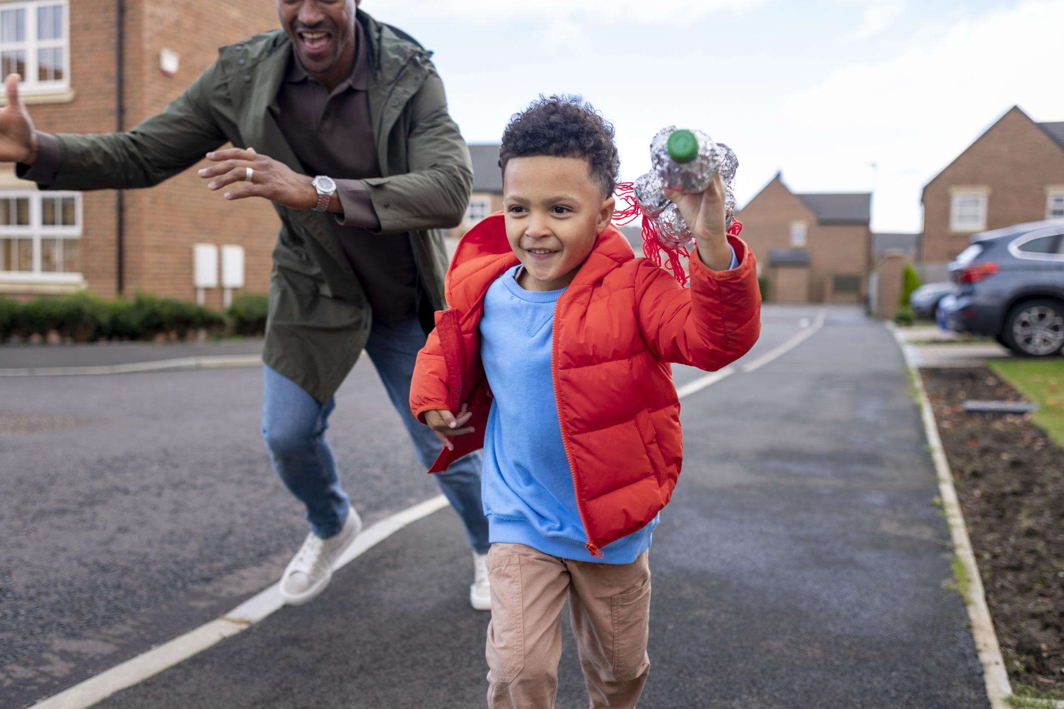 Child running ahead of adult on the pavement.jpg