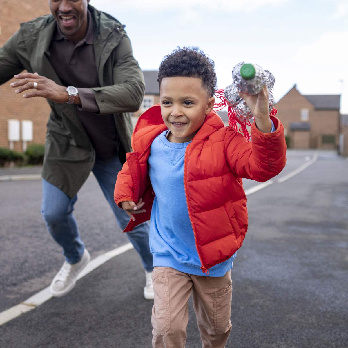 Child running ahead of adult on the pavement.jpg