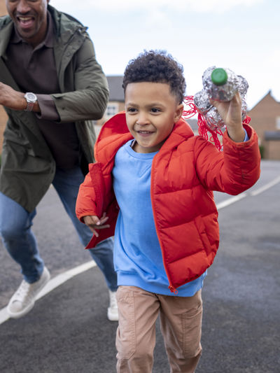 Child running ahead of adult on the pavement.jpg