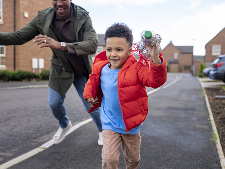 Child running ahead of adult on the pavement.jpg